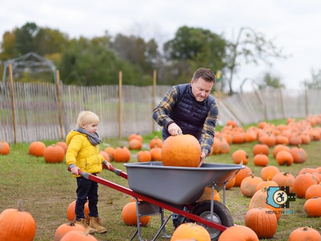 Father and Son Enjoying a Wheelchair-Accessible Pumpkin Patch