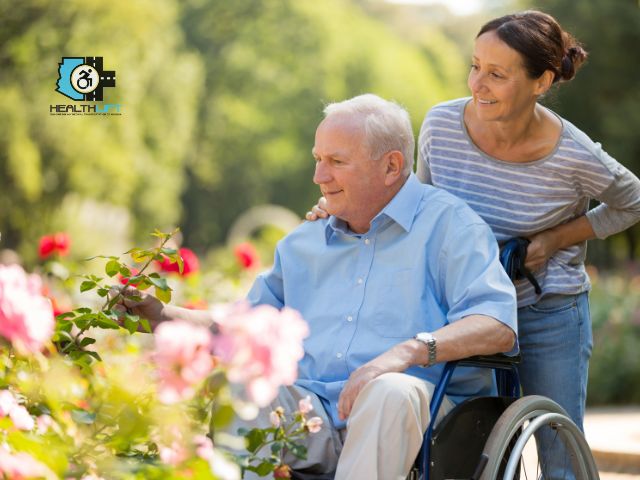 Caregiver for Disabled Family Member Assisting a Senior Man in a Wheelchair Outdoors, Sharing a Supportive and Compassionate Moment